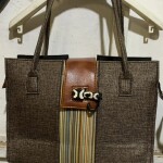 Hand bag with leather strip