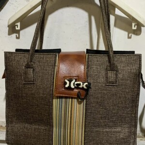 Hand bag with leather strip